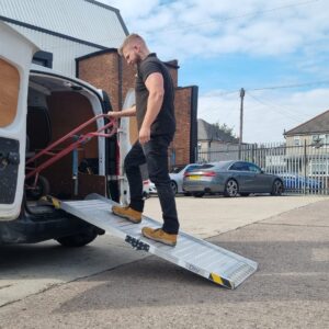 Custom metal loading ramp attached to the rear of a commercial van for safe access.