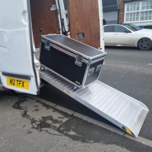 A tailor-made metal access ramp securely fitted to the back of a UK transport van.