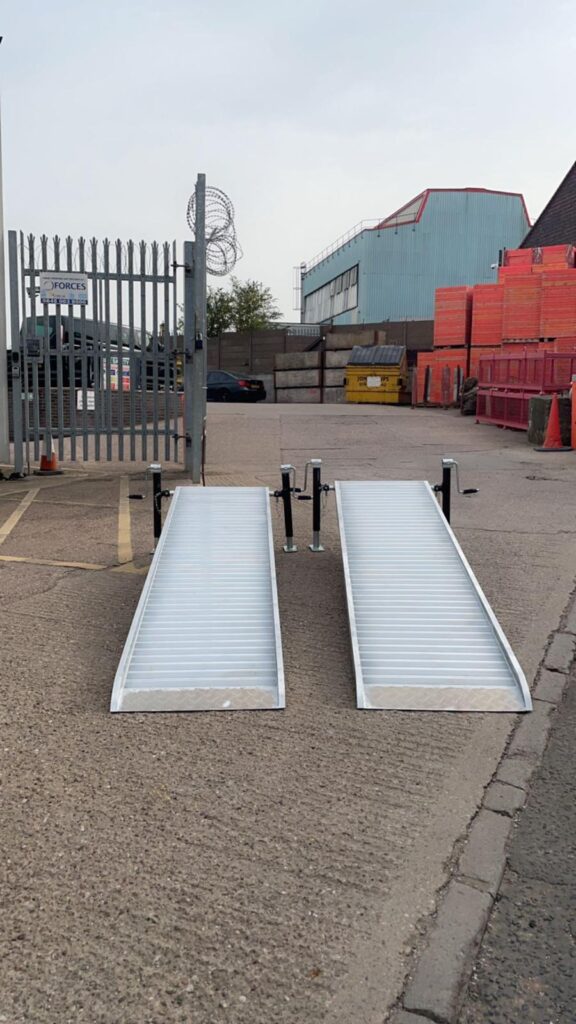 Custom metal loading ramp attached to the rear of a commercial van for safe access