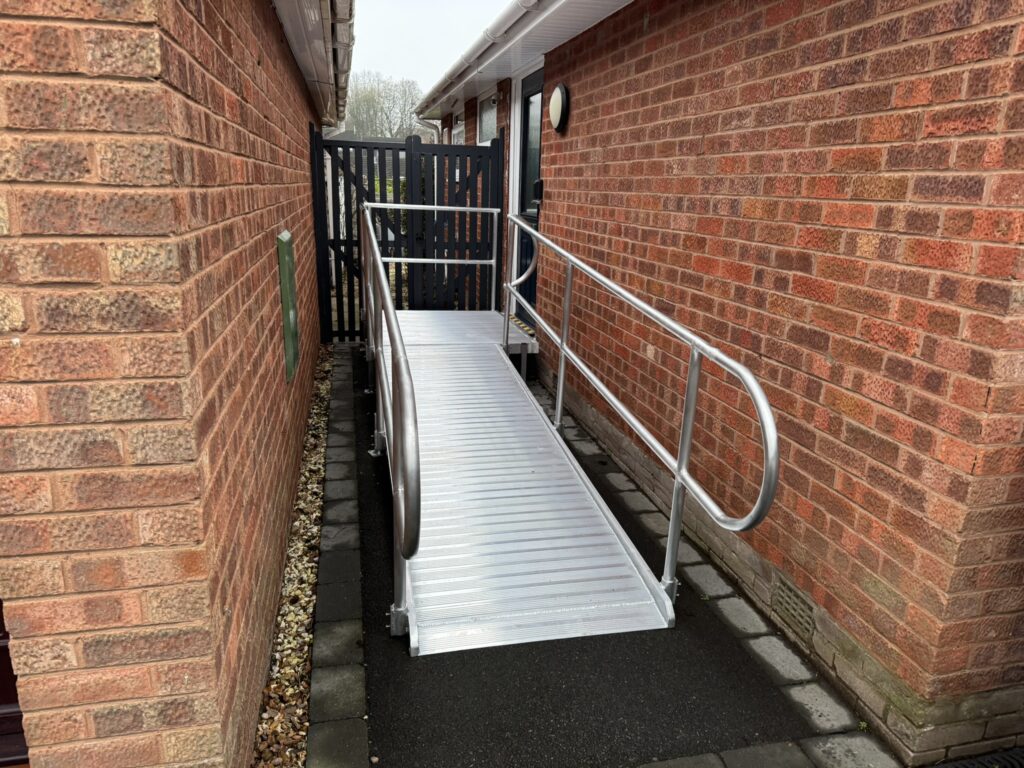 A durable metal wheelchair access ramp providing safe entry to a building.